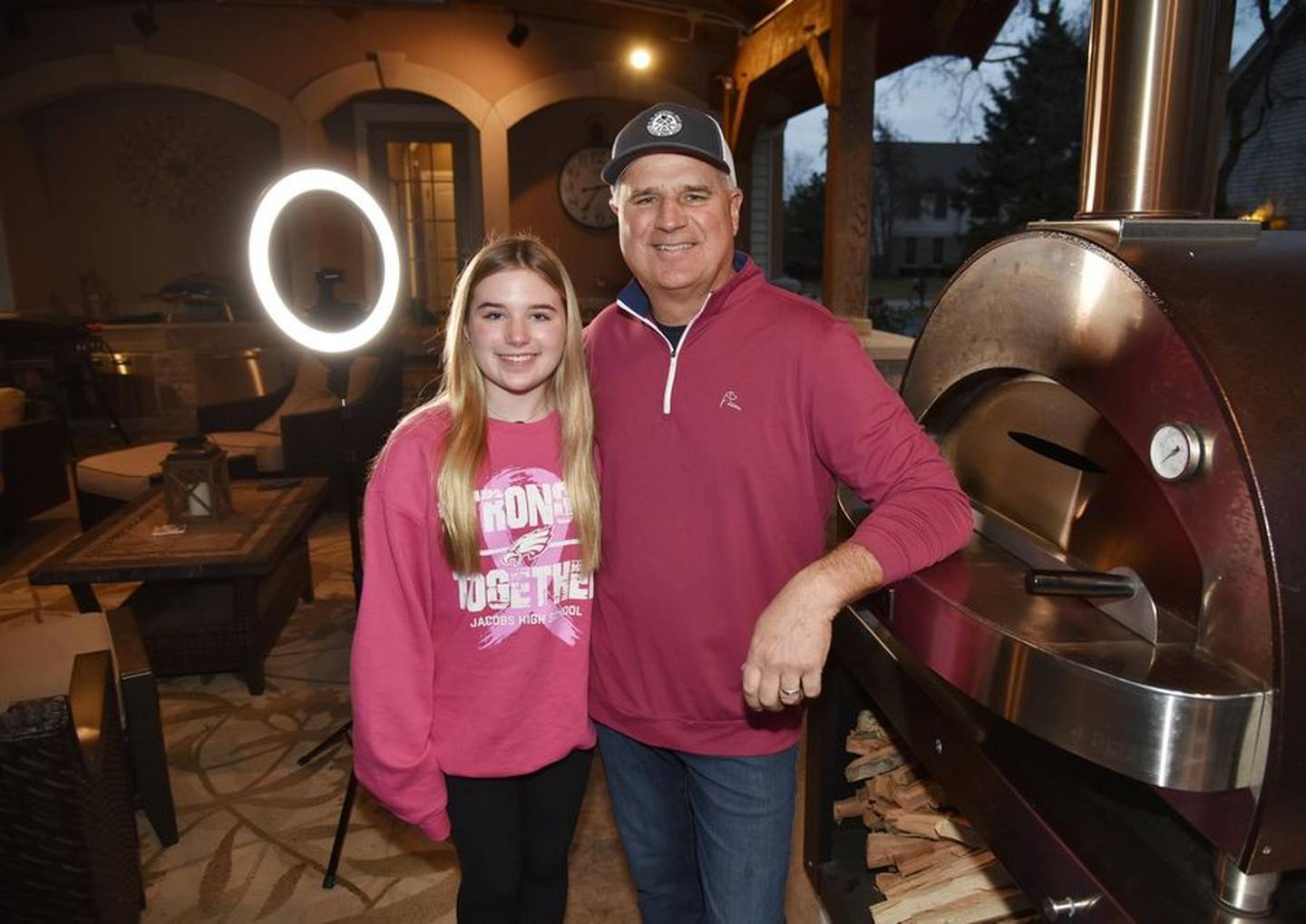 Fifteen-year-old Lindsey Postelnick, left, persuaded her dad, Darryl, to start making TikTok videos. Two years later, he has 2.7 million followers.