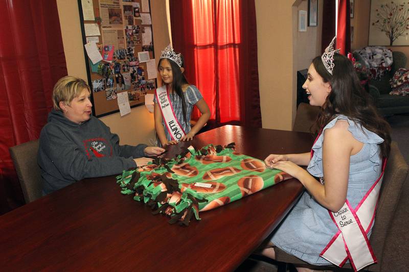Candace H. Johnson for Shaw Local News Network
April Soulak-Andrews, of Antioch, president and founder, talks with Audrey Ruhl, 10, of Antioch (Ms. Illinois PreTeen 2023) and Alexandra Lynch, 21, of Lindenhurst, (Miss Illinois 2023) after making a no-sew fleece blanket  together for the annual blanket drive for The Penny’s Purpose in Antioch. Both Audrey and Alexandra are youth ambassadors for The Penny's Purpose. (12/18/22)