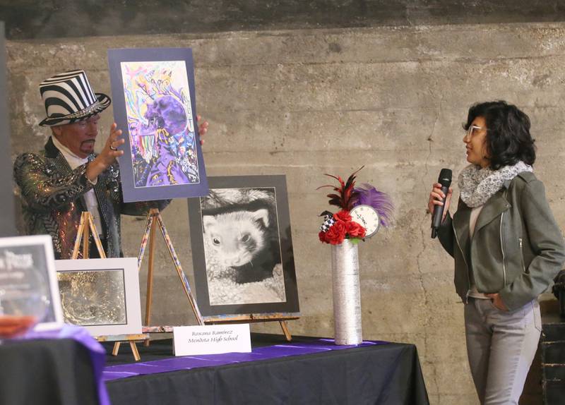 Roxanna Ramirez a senior at Mendota high school talks about her artwork with Don Grant Zellmer Madhatter host during the 7th annual Mad Hatter Ball on Friday, Nov. 17, 2023 at the Westclox Event Center in Peru.