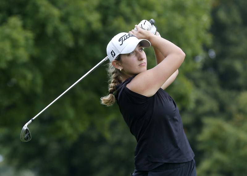 McHenry’s Madison Donovan watches her tee shot on the fourth hole during the Fox Valley Conference Girls Golf Tournament Wednesday, Sept. 20, 2023, at Crystal Woods Golf Club in Woodstock.