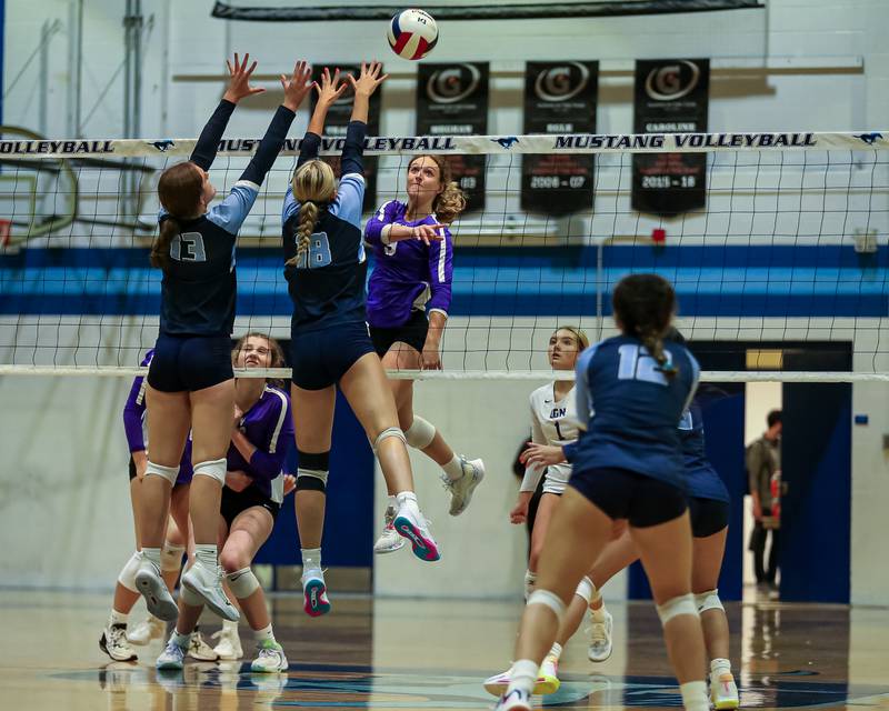 Downers Grove South's Alexis Gagnier (18) blocks a shot by Downers Grove North's Kelley Crowley (9) during volleyball match between Downers Grove North at Downers Grove South.  Sept 7, 20