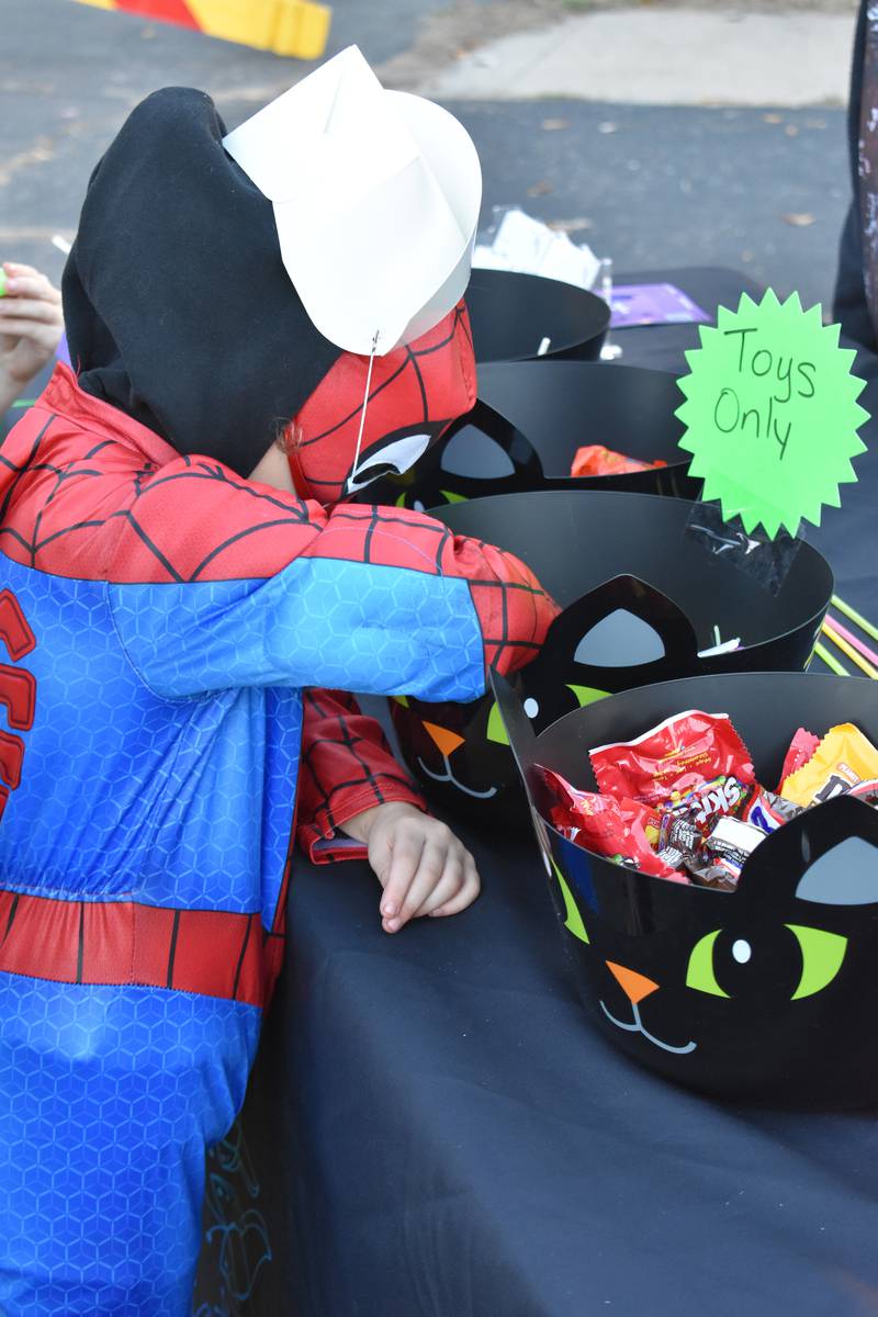 A youngster digs into a bucket for candy in Rock Falls on Friday, Oct. 24, 2025.
