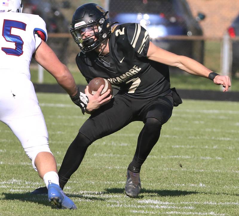 Sycamore's Elijah Meier puts a move on a Glenbard South defender Saturday, Nov. 6, 2021, during their IHSA Class 5A playoff game at Sycamore High School.