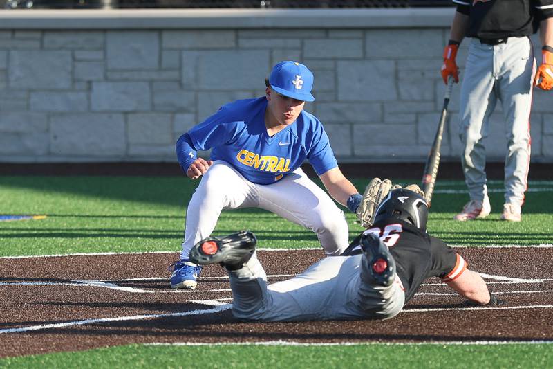 Joliet Central’s Vincent Perkins attempts a tag on Minooka’s Conor Powers on Monday, April 6, 2026 in Joliet.