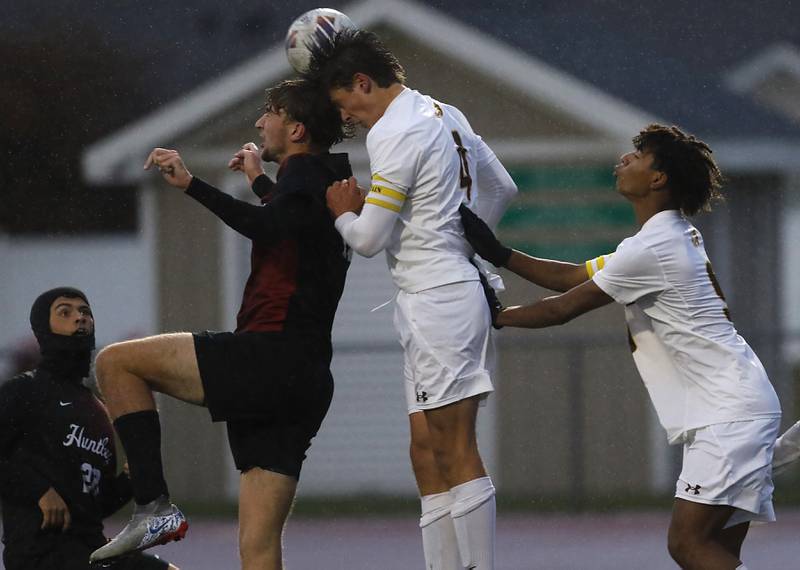 Huntley's Liam Nixon (left)  heads the ball in front of Jacobs' Josh Mickey (center) and Noah Anderson (right) during an IHSA Class 3A Huntley Regional boys soccer semifinal match on Tuesday, Oct. 21, 2025, at Huntley High School.
