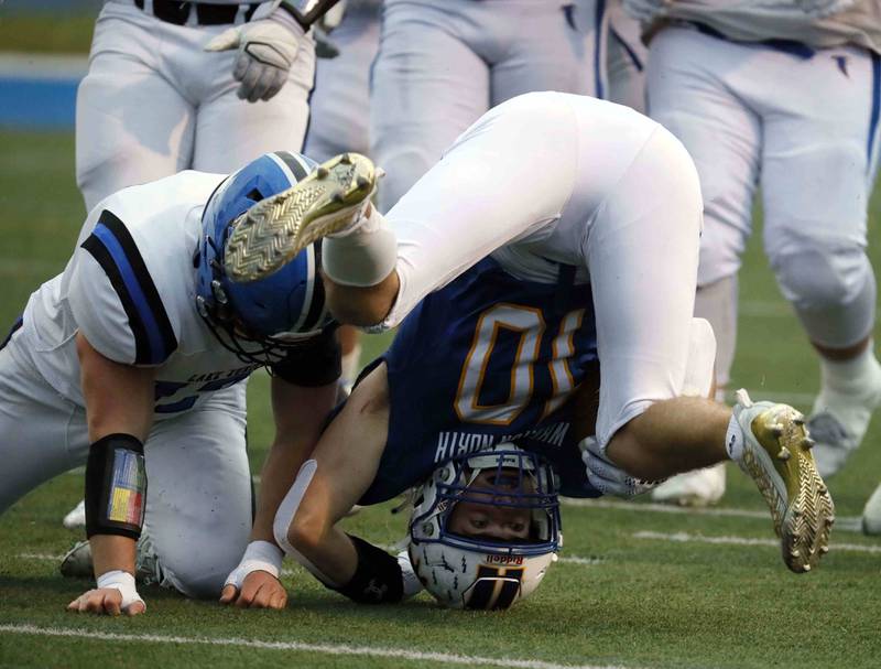 Brian Hill/bhill@dailyherald.com
Wheaton North's Tyler O'Connor (10) rolls on his head after being brought down by a Lake Zurich player during the second round of the IHSA playoffs Saturday November 5, 2022 in Wheaton.