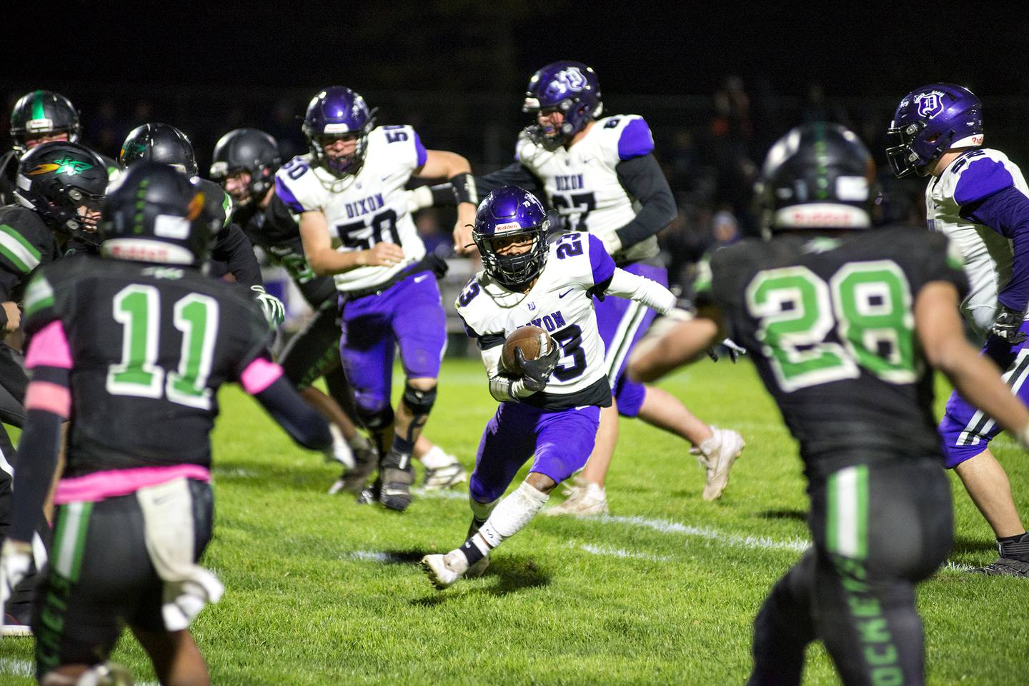 Dixon's Zavion Johnson looks for space while running against the Rock Falls defense Friday Oct. 22, 2021.