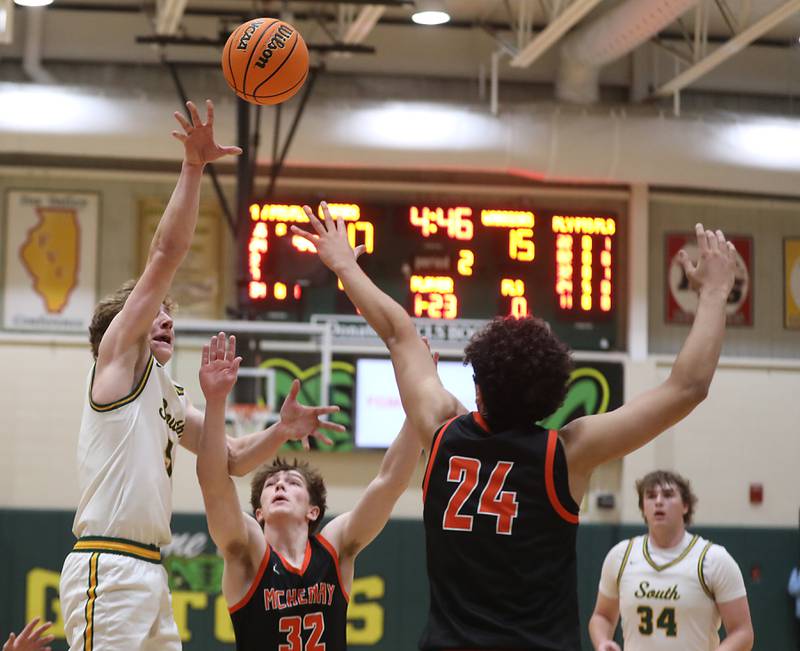 Crystal Lake South's Carson Trivellini shoots th ball over the defense of McHenry's Garet Lobbins (center) and  Adam Anwar (right) during a Fox Valley Conference boys basketball game on Wednesday, Jan. 14, 2026, at Crystal Lake South High School.