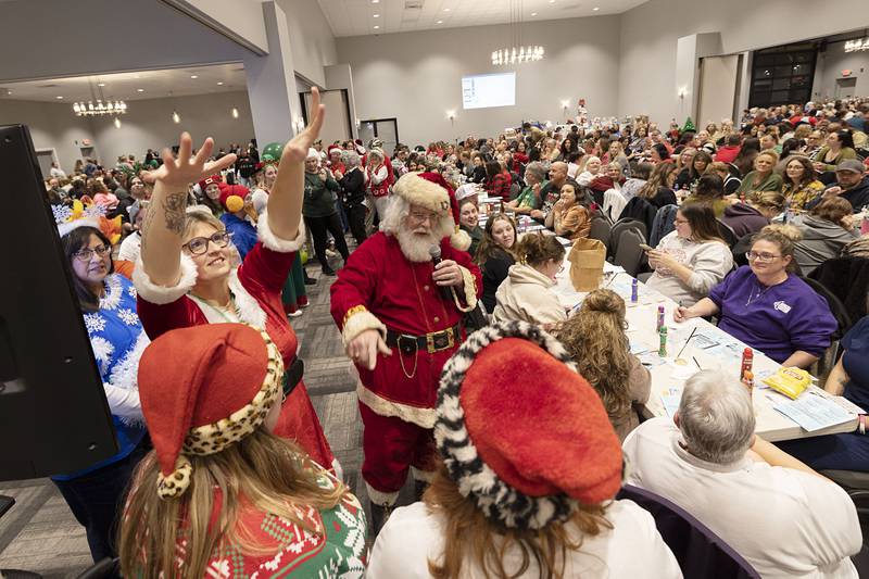 Santa points to contestants in the Hometown Holidays Bingo Christmas costume contest Thursday, Nov. 20, 2025, in Rock Falls.