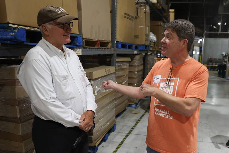 Feeding America supporter Brian Christner talks with South Suburban Center Food Bank Food Coordinator Steve Harold, in Joliet, during a stop from his walk across America. Brian started his fundraising journey in Delaware on February 19th and expects to finish outside San Francisco in December.