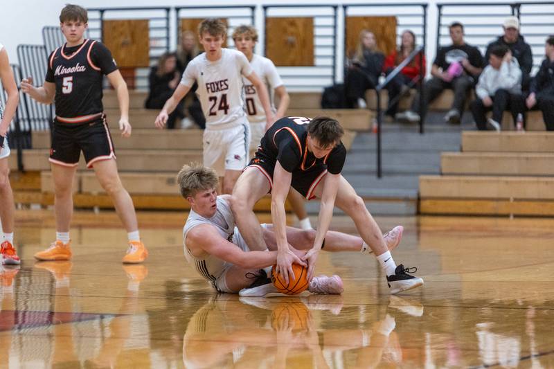 Yorkville's Frankie Pavlik battles Minooka's Kyle Rodak for a loose ball on Thursday, Jan.22,2026 in Yorkville.
