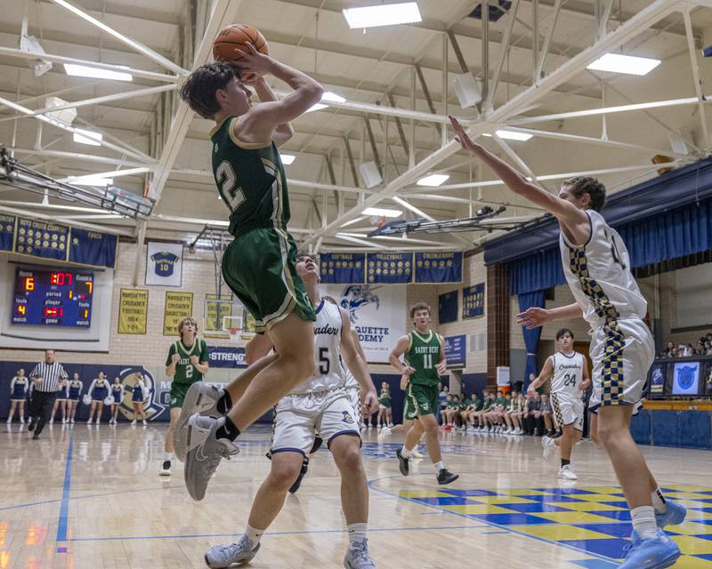 Carson Riva of St. Bede puts up a shot against a Marquette defender during the game on January 10, 2025 at Marquette Academy.