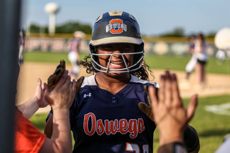 Oswego's Jaelynn Anthony (20) is greeted at the dugout after knocking in the winning run in their Class 4A Plainfield North Sectional final softball game against Wheaton North. May 31th, 2024.