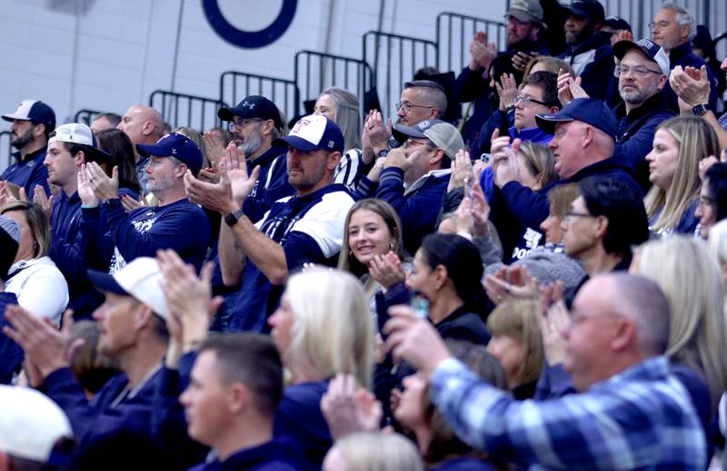 Community members acknowledge the Trojan players, coaches, and staff during a celebration of the IHSA Class 6A Champion Cary-Grove football team at the high school Sunday.