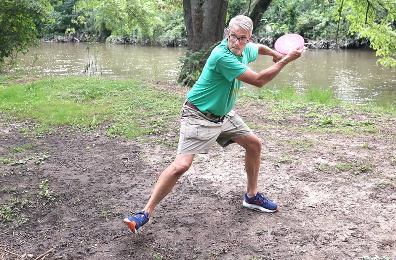 Brian Wallace, with the Kishwaukee Valley Wanderers, winds up for a shot Thursday, Sept. 2, 2022, at the new River Run Disc Golf Course in David Carroll Memorial Park in Genoa.