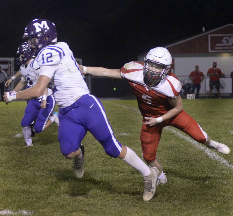 Streator’s Colin Jefferies tries to stop Manteo’s Kade Kasiewicz on a run in the 2nd quarter Friday at Streator.