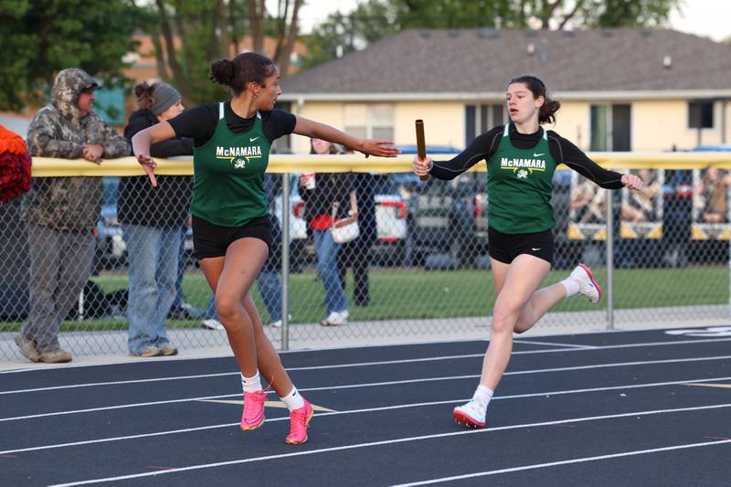 Bishop McNamara's Trinitee Thompson receives the handoff from Dylan Pallissard during the 4x200 relay race at the Herscher Track Invite on Friday, May 1, 2026.