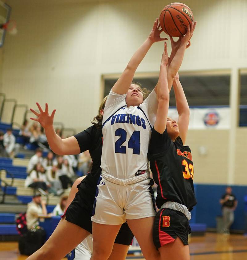 Geneva’s Kinsey Gracey (24) rebounds the ball against Batavia’s Natalie Warner (33) during a basketball game at Geneva High School on Friday, Dec 15, 2023.