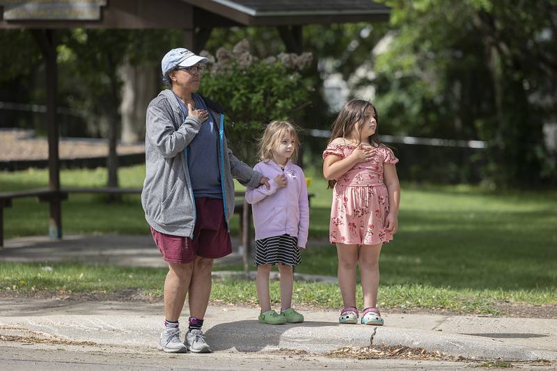Michelle Victum shows Jelly, 5, and Eternity, 7, how to honor the flag Monday, May 26, 2025, during Dixon’s Memorial Day parade.