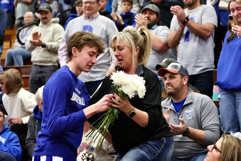 Jackson Mason and his mom, Heather, share a special moment before Friday's game at Prouty Gym. His dad, Pat, passed away unexpectedly on Monday. Each team member presented Heather with a carnation and PHS took a moment of silence in Pat's honor.