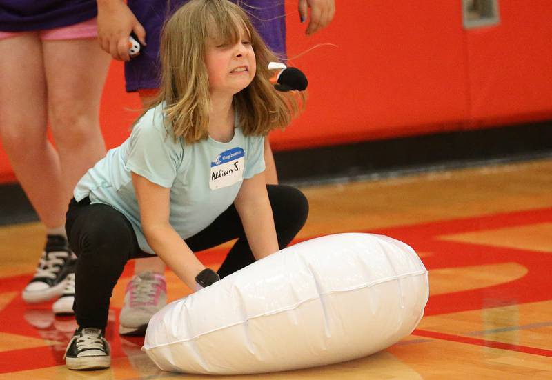Addison launches a penguin into the air during Inventor Camp on Friday, June 13, 2025, at Central Intermediate School in Ottawa.