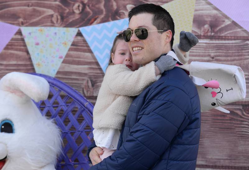 Ryan Lydon of LaGrange hold his daughter while she reaches to reacts to seeing the Easter Bunny during the LaGrange Easter Egg Hunt Saturday, March 23, 2024.