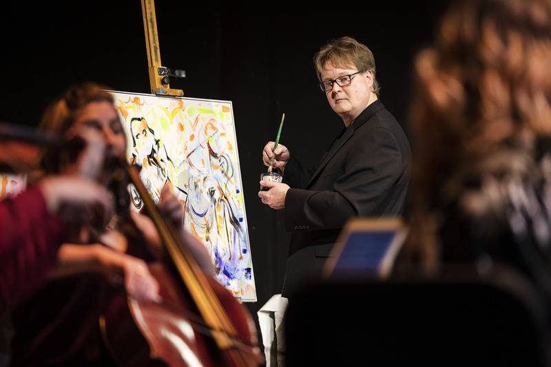 Painter Lewis Achenbach uses the music and musicians as his influence for his work Wednesday, Jan. 11, 2023 at Dixon Stage Left. At the end of the performance, Achenbach completed his own vision of the quartet at work.