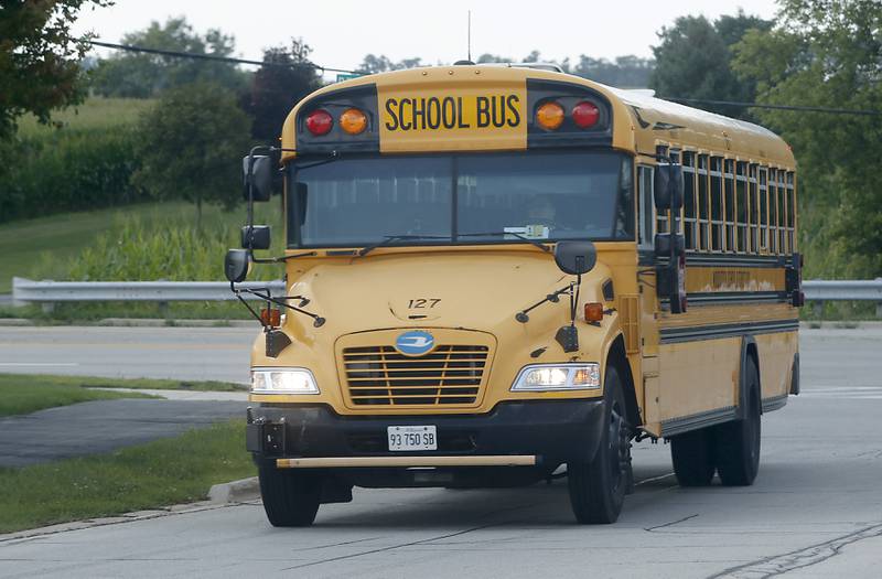 A Woodstock school bus travels to Prairiewood Elementary School to pick up students on Thursday, Aug. 17, 2023.