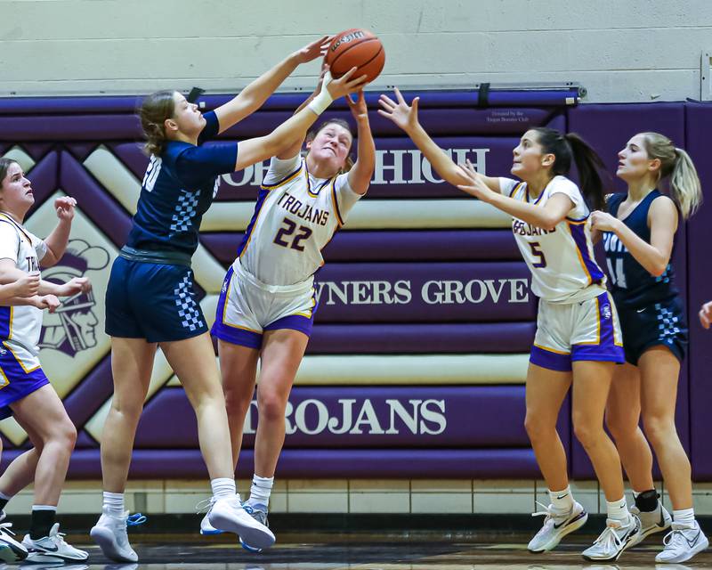 Downers Grove North's Lilly Boor (22) fights for possession during girls basketball game between Downers Grove South at Downers Grove North. Dec 16, 2023.