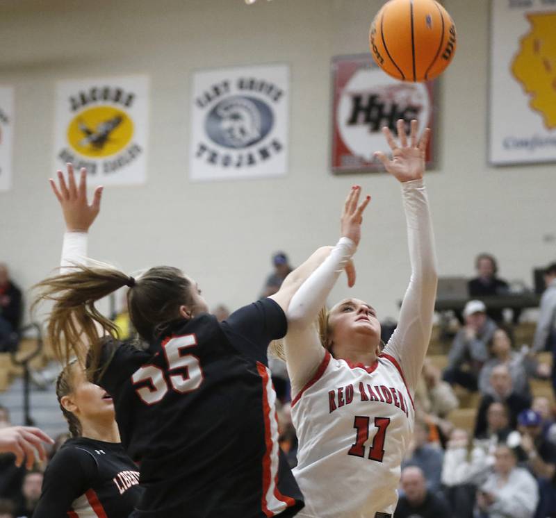 Huntley's Anna Campanelli (right) shoots the ball over \l35\ during the IHSA Class 4A Huntley Sectional Championship girls basketball game on Thursday, Feb. 27, 2025, at Huntley High School.
