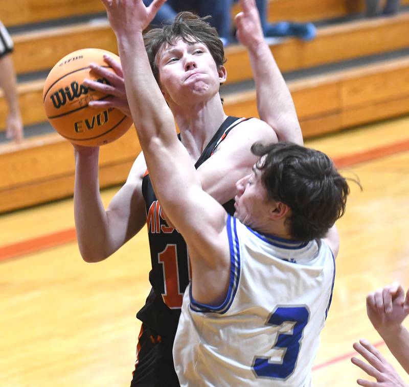 Milledgeville's Rayden Ehredt (15) shoots as Sterling Newman's Garret  Matznick (3) defends on Saturday, Dec. 13, 2025 at the 64th Annual Forreston Holiday Basketball Tournament at Forreston High School.