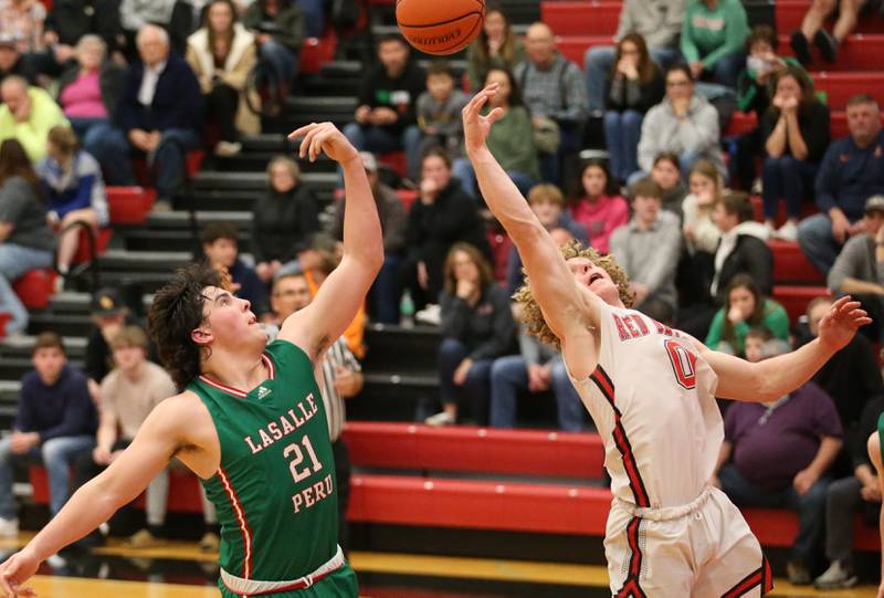 L-P's Josh Senica (21) and Hall's Mac Resetich (0) tip the ball in the air after going for a rebound at the same time on Tuesday, Nov. 29, 2022 at Hall High School in Spring Valley.