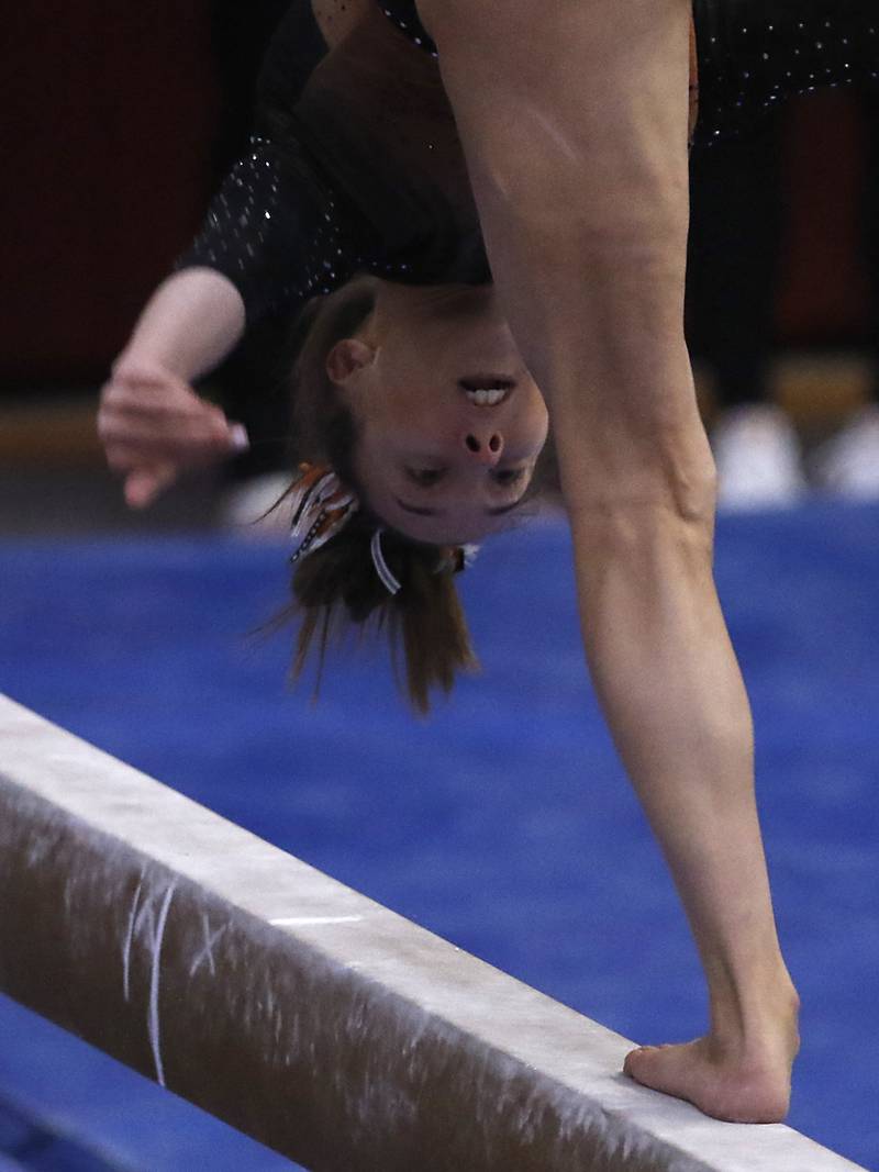 Libertyville’s Anna Baker competes in the preliminary round of the balance beam Friday, Feb. 17, 2023, during the IHSA Girls State Final Gymnastics Meet at Palatine High School.