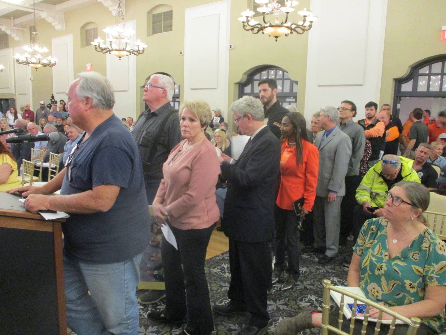 People line up at one of two microphones set up for those who wanted to speak Monday at a public hearing for Earthrise Energy's plan for a 6,100-acre solar complex in Will County. March 30, 2026