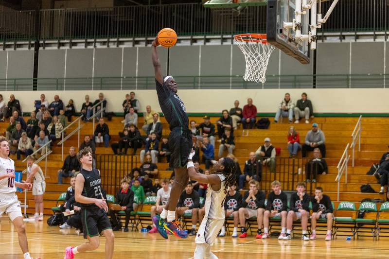 Glenbard West's Josh Abushanab goes in for the shoot over Yorkville's Alonn Flint on Friday Dec. 26,2025 at the 51st. Annual Jack Tosh Holiday Tournament in Elmhurst.
