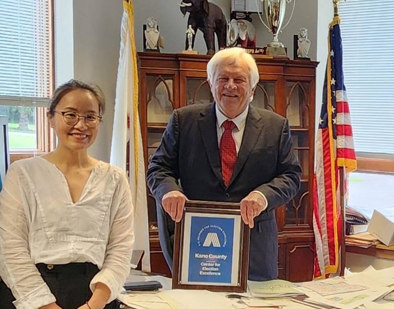 Kane County Clerk John Cunningham meets with city of Madison, Wis., Deputy Director Bonnie Chang during a tour of the Kane County Clerk’s Office to share and demonstrate best practices for vote-by-mail automation.