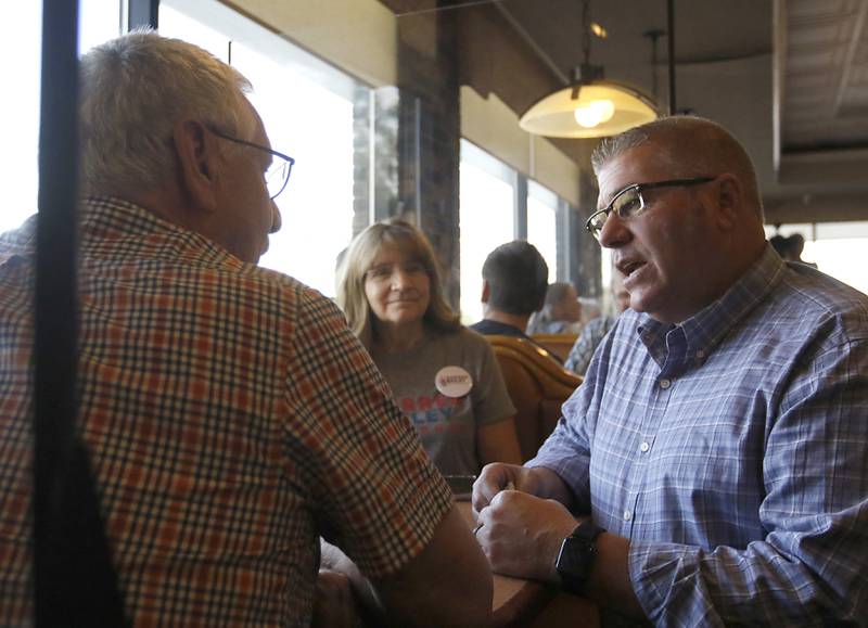 David MacPhail, left, of Wauconda, talks with Republican candidate for governor Darren Bailey as Bailey campaigns Wednesday, Sept. 21, 2022, at the Around the Clock Restaurant, 5011 Northwest Highway, in Crystal Lake, during a nine-city bus tour, with his Lt. Governor candidate Stephanie Trussell.
