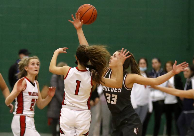 Prairie Ridge's Karsen Karlblom, right,  knocks the ball away from Deerfield's Nikki Kerstein as she passes the ball during a IHSA Class 3A Grayslake Central Sectional semifinal basketball game Tuesday evening, Feb. 22, 2022, between Prairie Ridge and Deerfield at Grayslake Central High School.