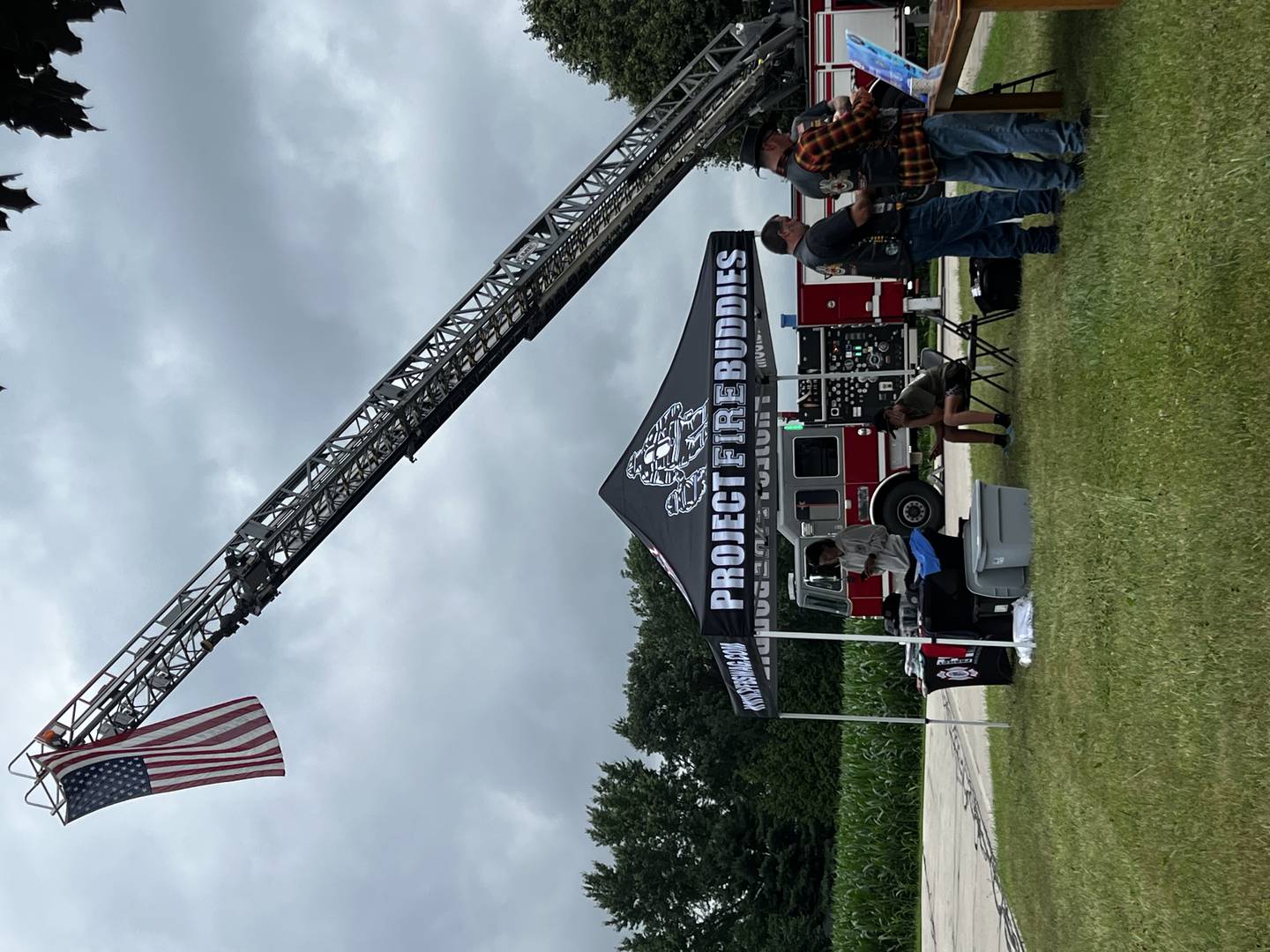 Sycamore Fire Department flies the American flag before a charity bike ride in July 2025 for Project Fire Buddies.