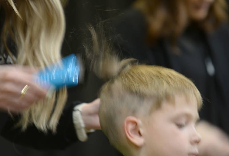 Forest Road students including 1st grader Luke Bocian get their heads shaved by D'Amici hair stylists during the St. Baldrick fundraiser held Thursday, March 7, 2024.