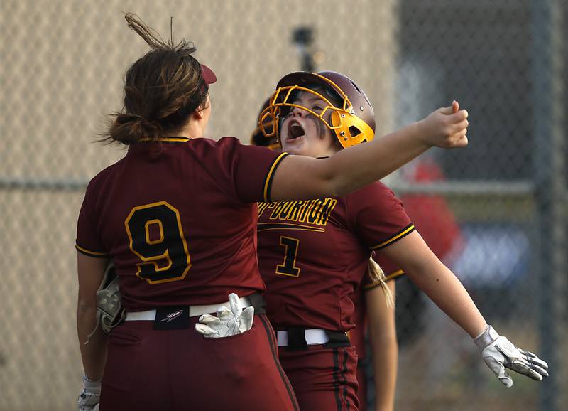Richmond-Burton's Norah Spittler, left, and Lyndsay Regnier celebrate Regnier scoring a run during a nonconference softball game Wednesday March 16, 2022, between Crystal Lake Central and Richmond-Burton at Lippold Park in Crystal Lake.