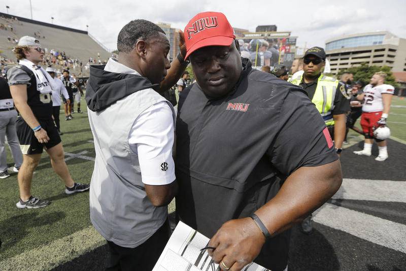 Northern Illinois head coach Thomas Hammock (right) congratulates Vanderbilt head coach Derek Mason after a game Saturday in Nashville, Tenn.