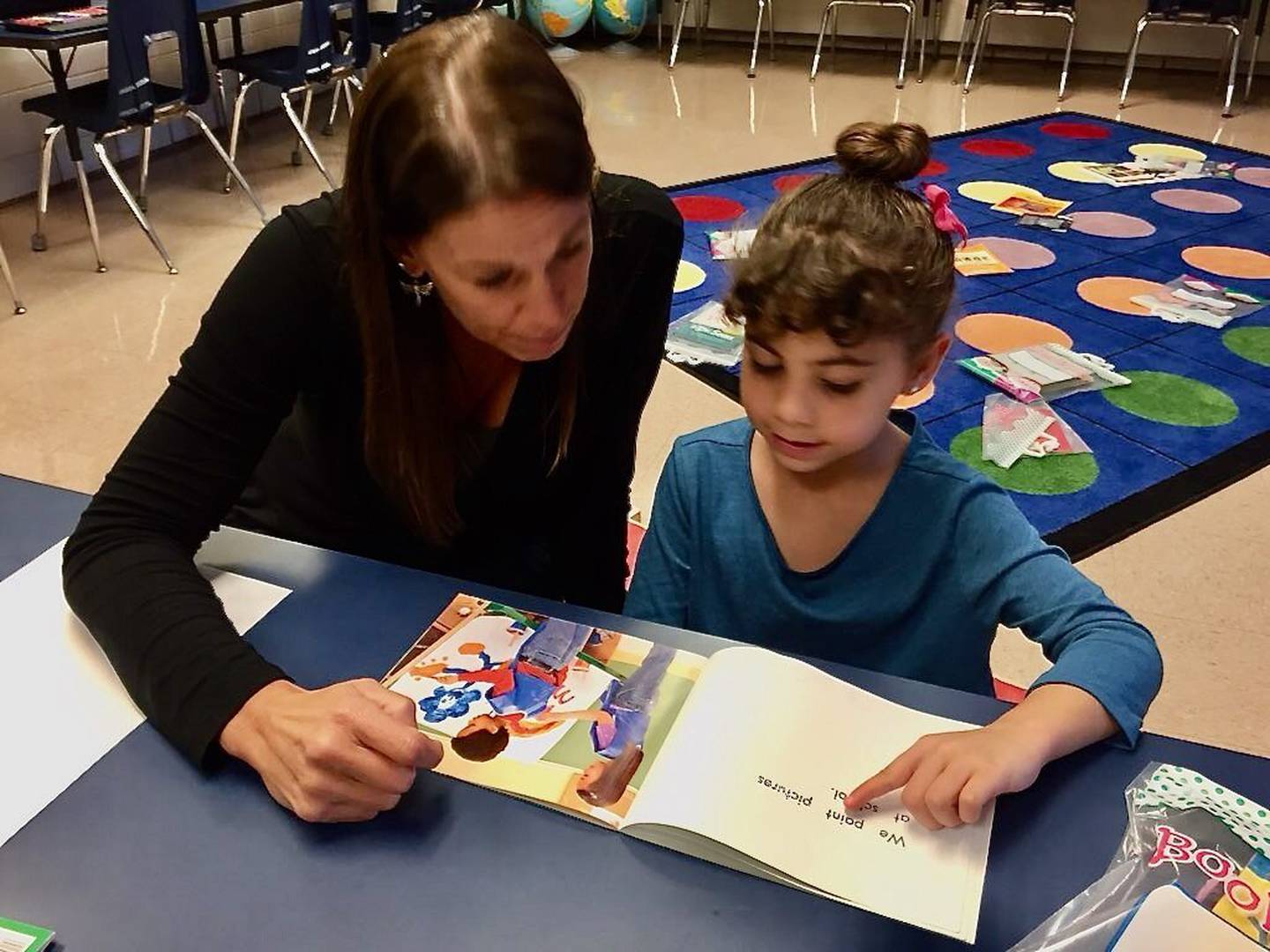 St. Charles School District 303 reading specialist Amy Kappele works one-on-one with a student.