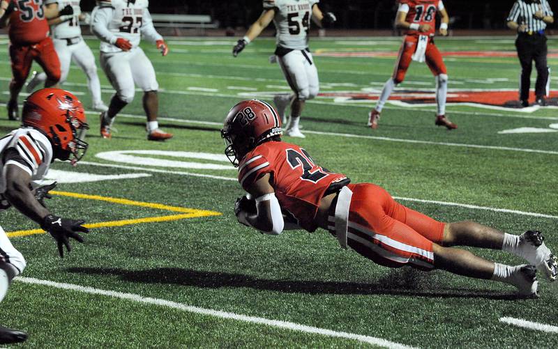Yorkville running back Tavaris Harland, Jr (28) makes a diving catch in front of a Bolingbrook defender on Friday, Sept. 27, 2024, during a varsity game at Yorkville High School.