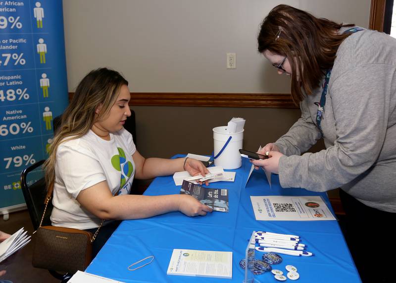 Hira Khan (left) from Be the Match helps Jenna Lane (right) get swabbed at the Be the Match Stem Cell Screening and Blood Donation Event at Elburn's Lion's Club that was held for Frankie Techter on Saturday, April 8, 2023.