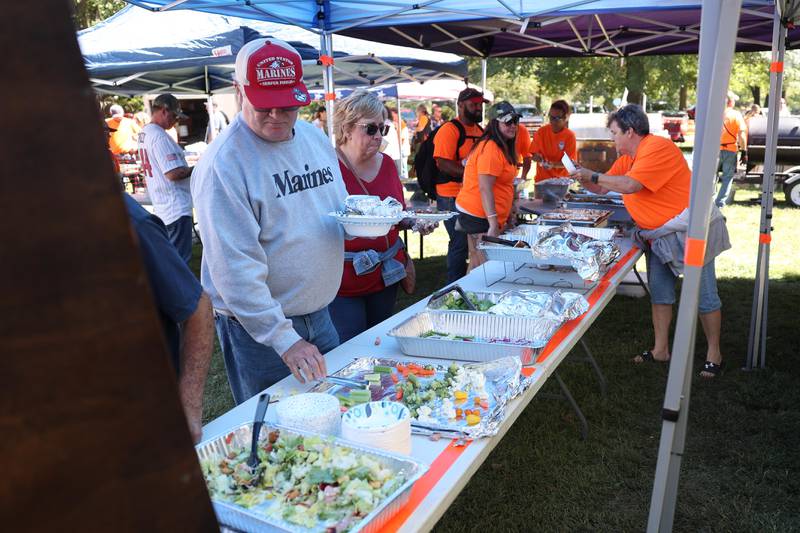 Veterans and family get food at the 11th Annual Operation Firm Handshake Veteran’s Picnic on Saturday, Sept. 7, 2024 in Coal City.