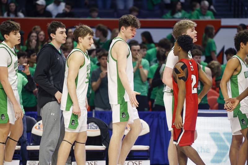 York players greet Marist after loosing in the IHSA Class 4A boys basketball state semifinal Friday, March 13, 2026 at the State Farm Center in Champaign.