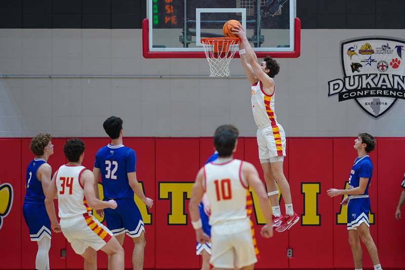Batavia's Jax Abalos (3) dunks the ball off of a backdoor cut against Marmion during a basketball game at Batavia High School on Wednesday, Nov. 27, 2024.