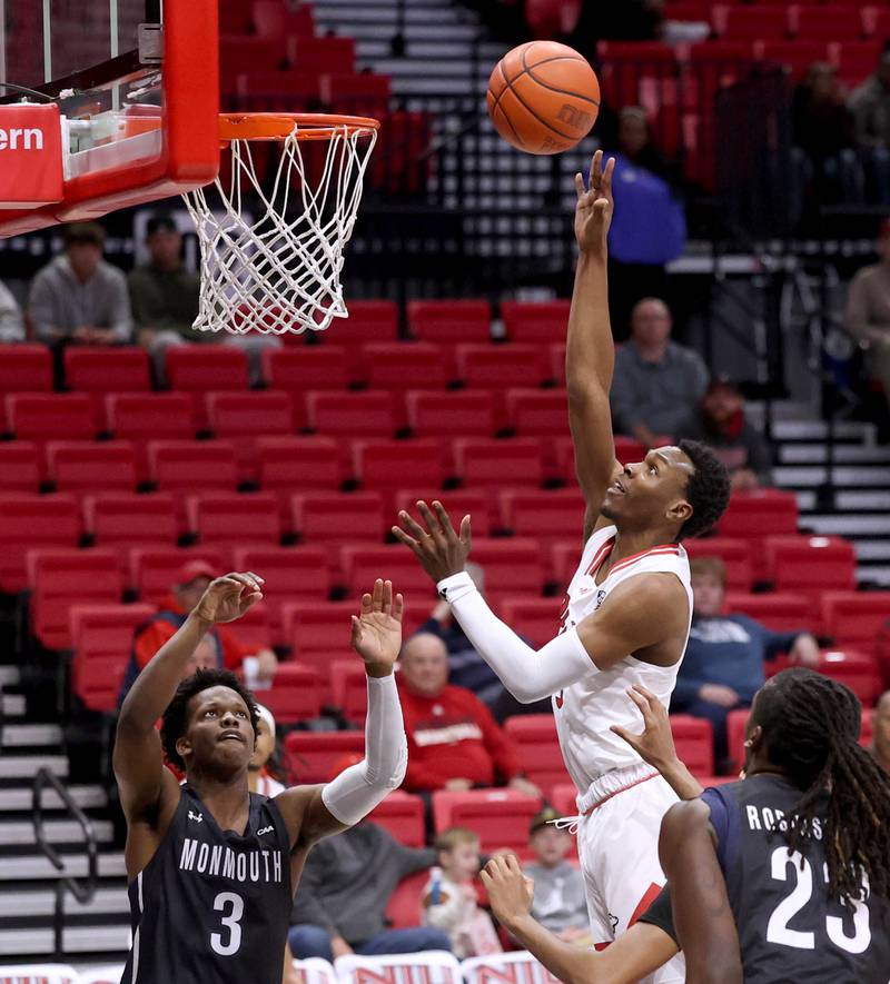 Northern Illinois' Joe Munden Jr. goes to the basket between Monmouth defenders during their game Tuesday, Nov. 12, 2024, in the Convocation Center at NIU in DeKalb.