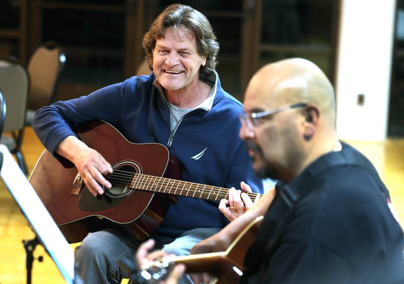 Veterans Ron Lofton (left) and Manuel Olalde play a song on guitar Tuesday, Nov. 26, 2024 during the Kishwaukee Special Recreation Association’s Chords and Camaraderie at the Hopkins Park Community Center in DeKalb.